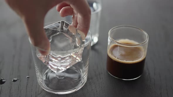 Slow Motion Making Espresso Tonic in Tumbler Glass Put Ice Cube in Glass