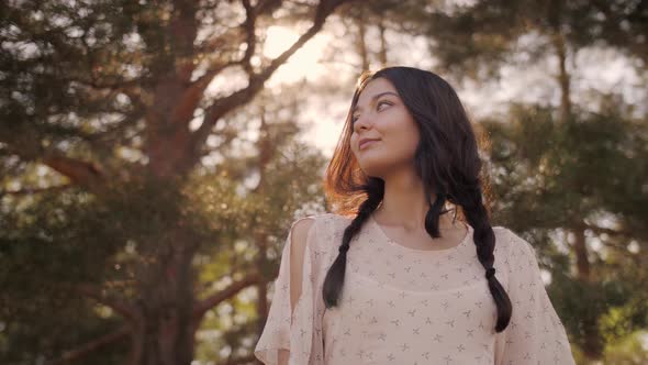 Happy woman in Forest Enjoying Nature