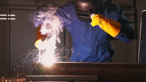 Metal Welder Working with Arc Welding Machine