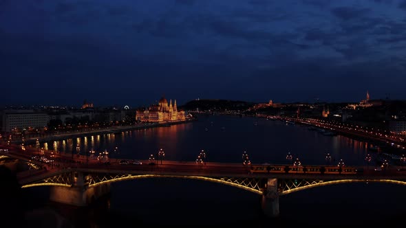 Aerial Wide Shot of Danube River and Budapest City Skyline at Night Time