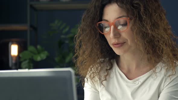 Portrait of a Beautiful Middleaged Woman Working at the Laptop