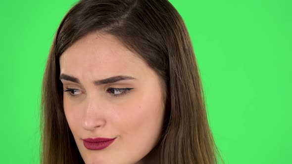 Lovely Girl Is Very Offended and Looks Away. Close Up. Green Screen