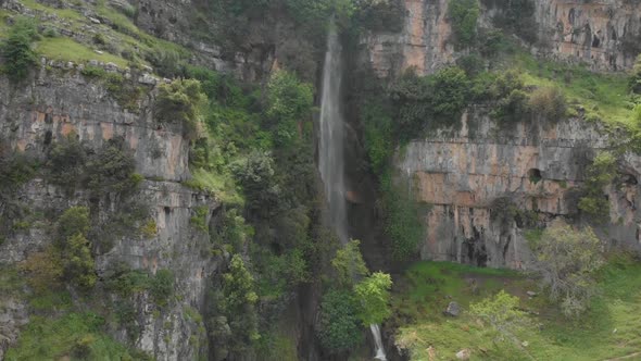 Drone footage flying downward a water fall in old Akkar