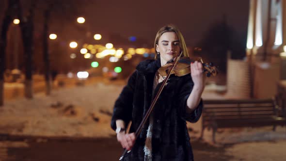 Playing Violin Instrument in the Winter Time
