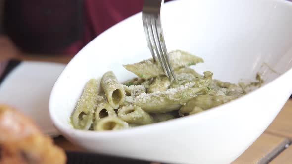 Women Eating Homemade Cooked Pasta in a Plate on Table