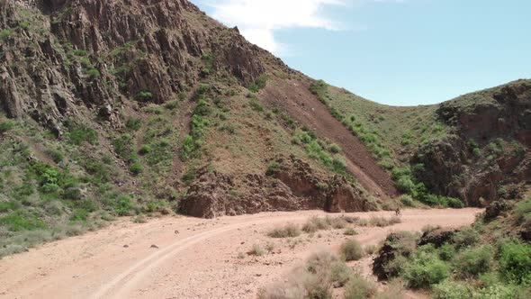 Drone Shot of Bicyclist Ride in the Desert Canyon