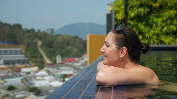 Girl Looks at Picturesque Hilly Landscape with Green Trees