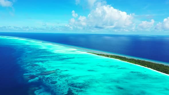 Tropical aerial clean view of a white paradise beach and aqua blue water background in hi res 4K