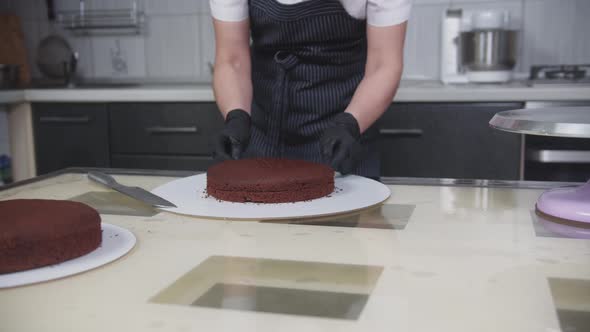 Confectionery  a Woman Cuts a Chocolate Sponge Cake Into Two Parts Using a String