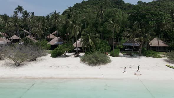 An Aerial View of a Romantic Couple Walking on Beautiful Tropical Beach