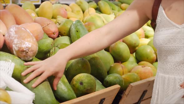 Pretty Young Woman Is Making Purchases in the Supermarket, Choosing Products at the Supermarket for