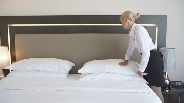 Nice Maid Prepares a Bed for Guests