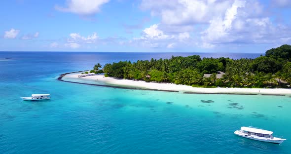 Wide drone travel shot of a white sandy paradise beach and aqua turquoise water background in 4K