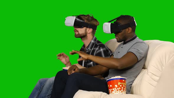 Men in VR Masks Watching a Movie with Popcorn. Green Screen