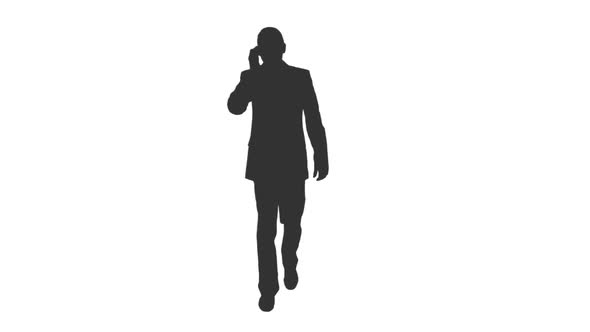 Silhouette of Business Man in Suit Talking on Smartphone While Walking