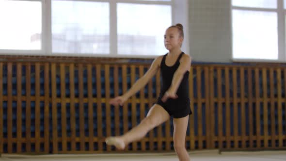 Girl Performing Front Splits when Jumping