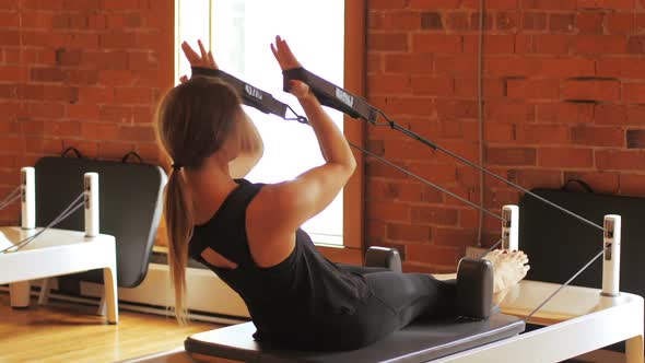 Woman exercising on gym equipment