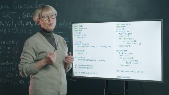 Portrait of Mature Woman Teaching Online Class Explaining Software Development Pointing at Digital