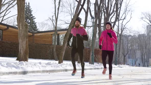 Fit Couple Jogging Together in Winter Park