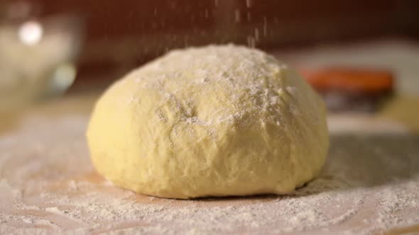 Sprinkling yeast dough with flour