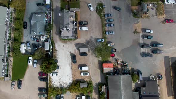 Top view of buildings, houses, warehouses and cars in urban area near the pier