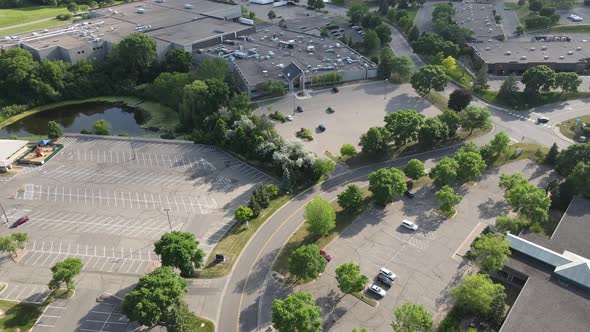 Aerial view over industrial business park in Minneapolis, Minnesota, area with ponds and trees.