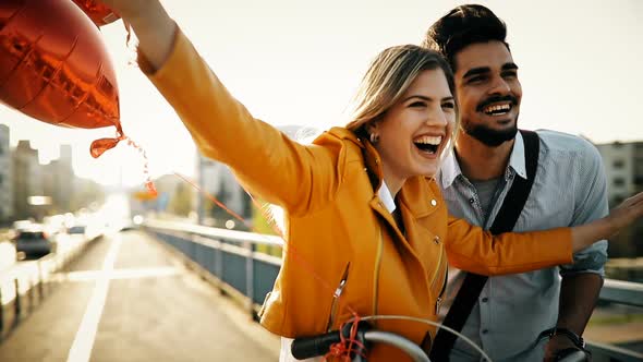 Young Loving Couple Dating While Riding Bicycles in the City