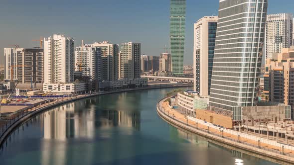 Skyscrapers Near Canal in Dubai with Blue Sky Aerial Timelapse