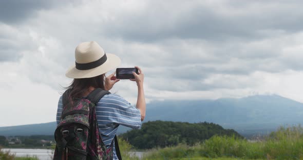 Woman Take Photo on Cellphone in Fujisan