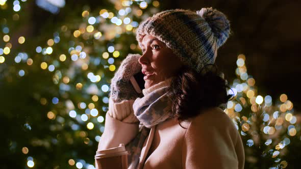 Happy Woman Calling on Smartphone on Christmas