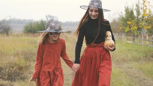 Girls in Halloween Costumes Walking Holding Hands