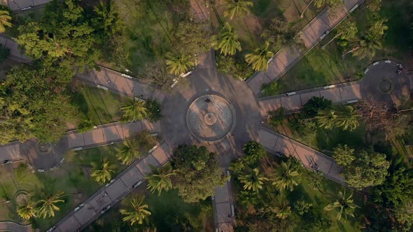 Central Fountain Surrounded With Paths And Tree Palms At Jardín Núñez In Colima, Mexico. Drone Ascen