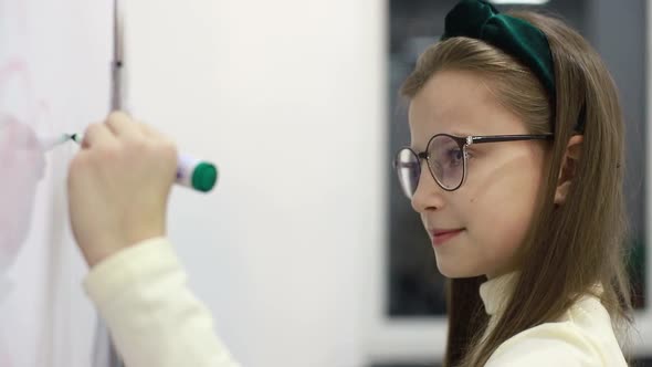 Little Girls Near Blackboard in Elementary School