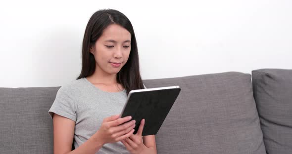 Woman watching tablet at home