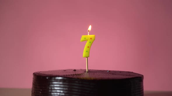 Chocolate Birthday Cake with Wick Lighting Trying to Blowout Candle