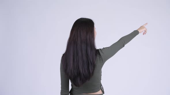 Rear View of Young Woman Thinking and Pointing Finger