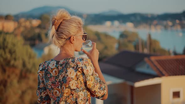 Lady Relaxing Leisure Celebrating Holidays Vacation Sunset. Woman Hold Wineglass And Drinking Wine.