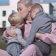A beautiful young mother hugs her sons and kisses them. - VideoHive Item for Sale