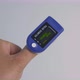 An Adult Person Uses the Pulse Oximeter to Measure the Oxygen Saturation - VideoHive Item for Sale