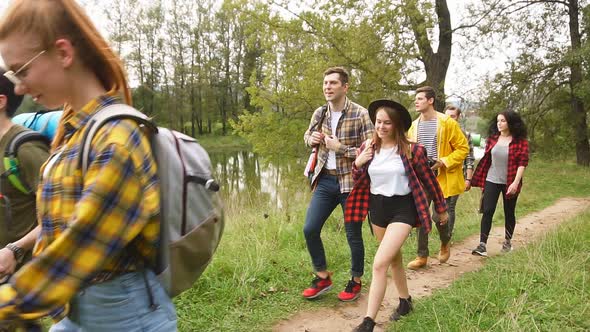 Group Friends Walking in a Forest, Looking for a Place To Stay. Slow Motion