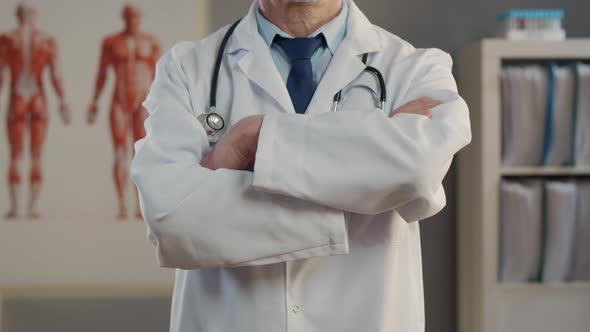 Doctor Standing with Arms Crossed in Hospital Office.