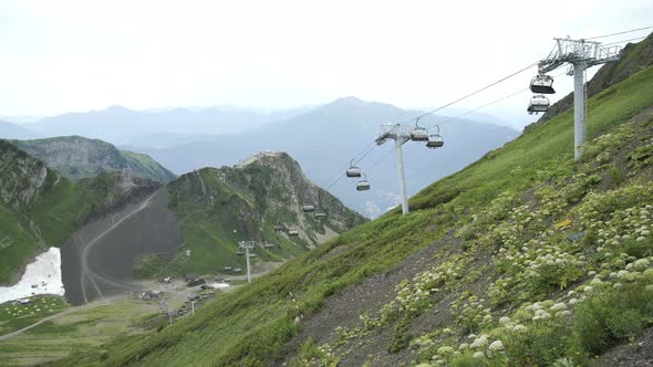 Iron Cabins of Cableway in Mountains in the Summer. Lift in the Mountains in Summer