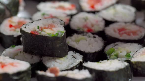 The Chef Lays Down Sets for Delivery Pieces of Sushi and Roll Made From Seafood with Asian