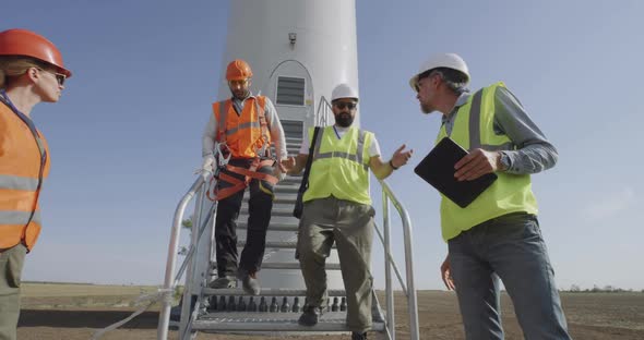 Engineers Inspecting Wind Farm Construction Site