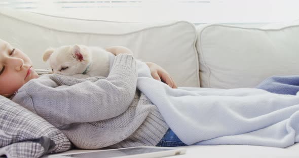 Little girl sleeping on sofa holding her pet in her arms 4K 4k