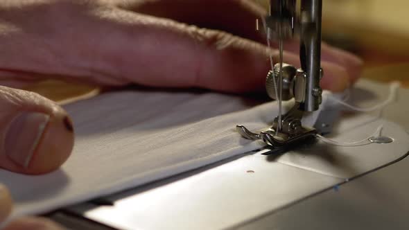 Tailor at Sewing Machine Sews a Homemade Medical Face Mask To Protect Covid-19