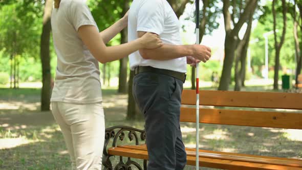 Female Volunteer Helping Blind Pensioner Outdoors, Social Programs, Support