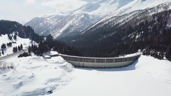 Shot of a reservoir in the Swiss alps. Camera flies up and tilts down.