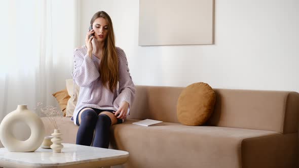 Excited Serious Woman Talking On The Phone At Home. Bad Or Unpleasant News