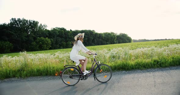 Woman Riding Bicycle in Countryside